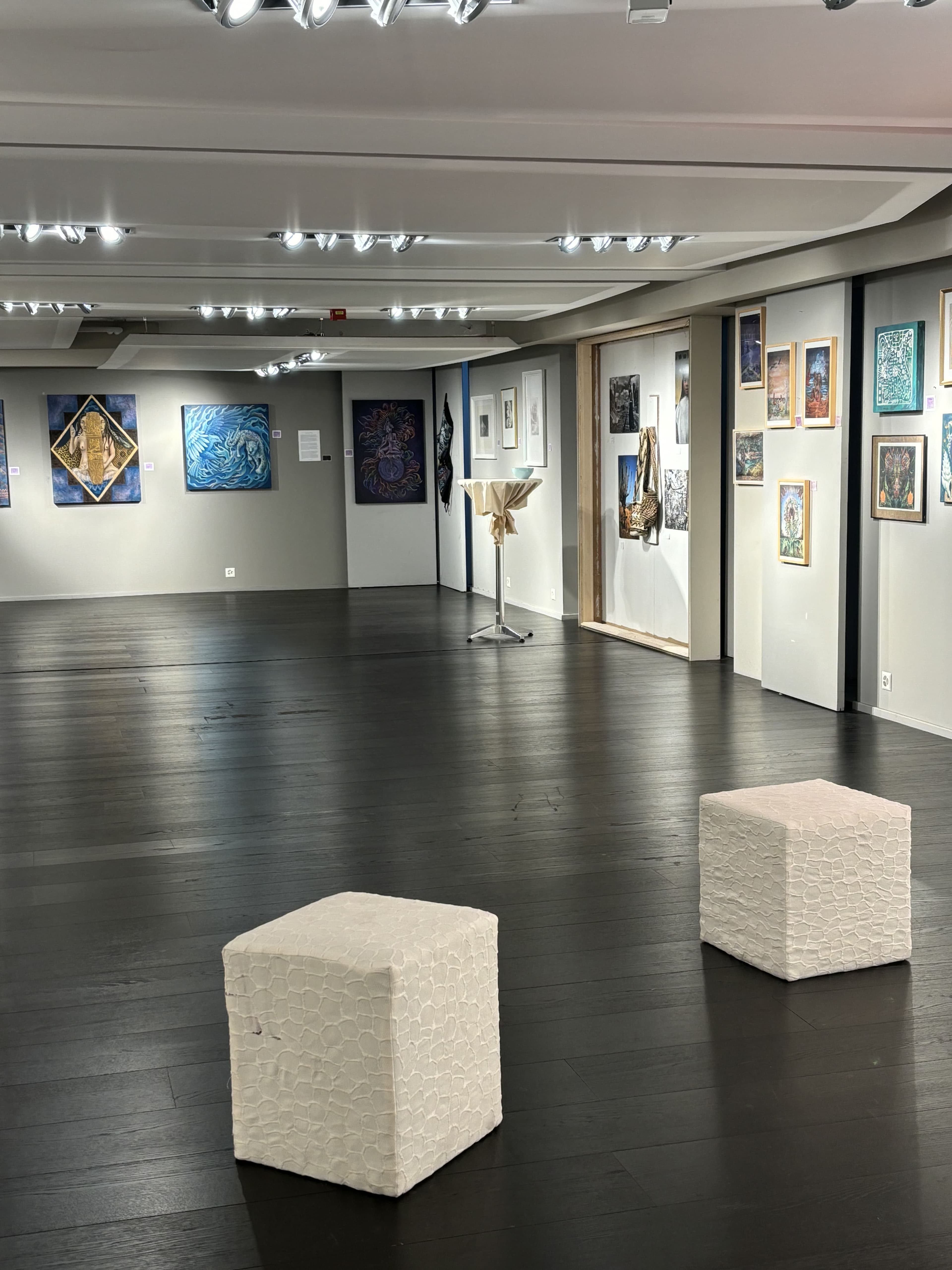 Visionary paintings in a white exhibition hall